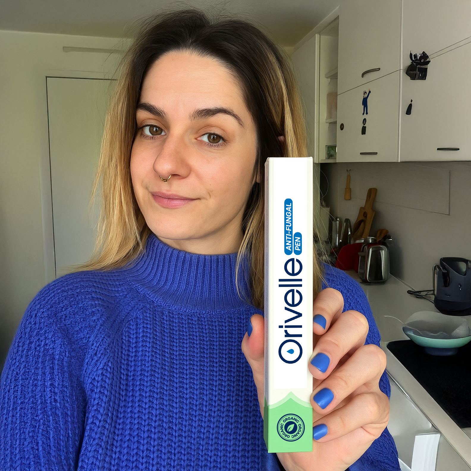 Person holding Orivelle product packaging at home